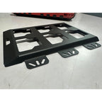 Black metal license plate holder on a light gray surface