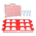 Red and pink plastic trays with small components on a white background